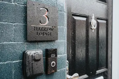 a door with the number three on a brick wall at HARROW LODGE - Strictly NO Parties in Liverpool