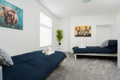 a bedroom with two beds and a couch at HARROW LODGE - Strictly NO Parties in Liverpool