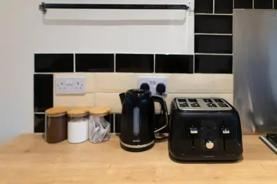 a kitchen counter with a toaster and other appliances at Modern cottage WiFi Free Parking in Penwortham