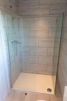 a shower with a glass door in a bathroom at Modern cottage WiFi Free Parking in Penwortham