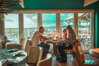 a group of people sitting at a table in a restaurant at The Wellsprings Lodges and Restaurant in Clitheroe