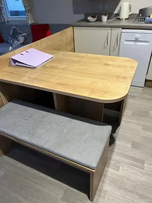 a wooden table with a bench in a kitchen at Lorraine's Caravan Holiday in Morecambe