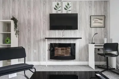 a living room with a fireplace with a flat screen tv at The Point , 2 Bed, Parking - Pass the Keys in Knowsley