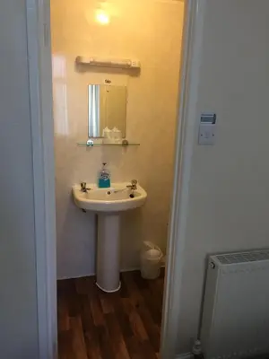 a bathroom with a sink and a mirror at Chaplins in Blackpool