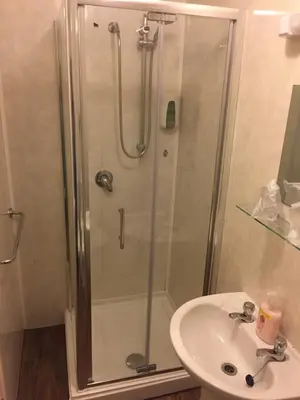 a bathroom with a shower and a sink at Chaplins in Blackpool