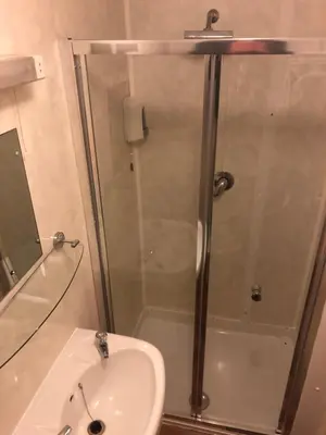 a bathroom with a shower and a sink at Chaplins in Blackpool