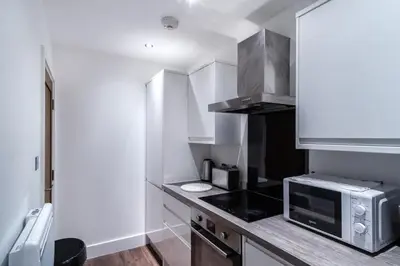 a small kitchen with a microwave and a counter at Central Liverpool 1 Bed Apartment w Balcony in Liverpool