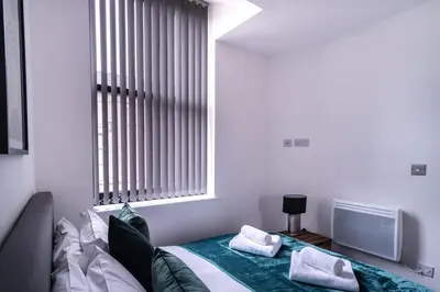 a bedroom with a bed with two pillows on it at Central Liverpool 1 Bed Apartment w Balcony in Liverpool