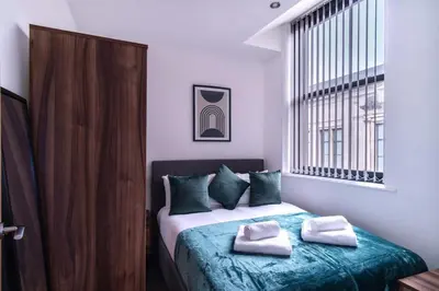 a bedroom with a bed with two towels on it at Central Liverpool 1 Bed Apartment w Balcony in Liverpool