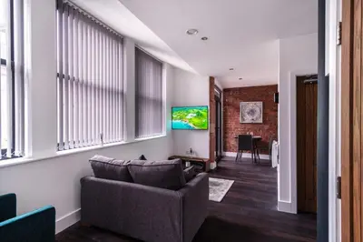 a living room with a couch and a tv at Central Liverpool 1 Bed Apartment w Balcony in Liverpool