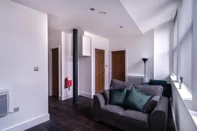 a living room with a couch and a tv at Central Liverpool 1 Bed Apartment w Balcony in Liverpool