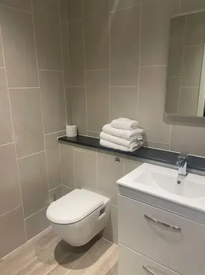 a bathroom with a white toilet and a sink at 1 Bed Apt - Balcony - City View - Great Location in Liverpool