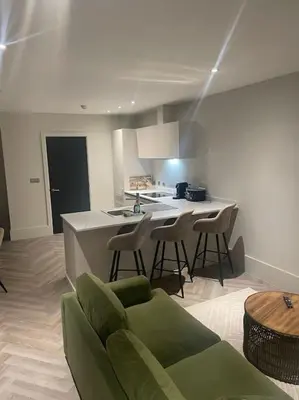 a kitchen with a couch and chairs in a room at 1 Bed Apt - Balcony - City View - Great Location in Liverpool