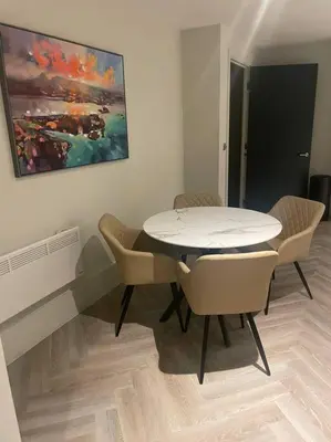 a dining room with a white table and chairs at 1 Bed Apt - Balcony - City View - Great Location in Liverpool