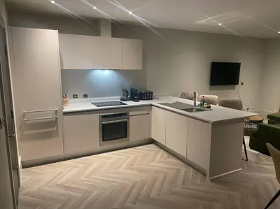 a kitchen with white cabinets and a counter top at 1 Bed Apt - Balcony - City View - Great Location in Liverpool