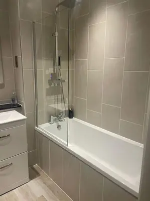 a bathroom with a shower with a tub and a sink at 1 Bed Apt - Balcony - City View - Great Location in Liverpool