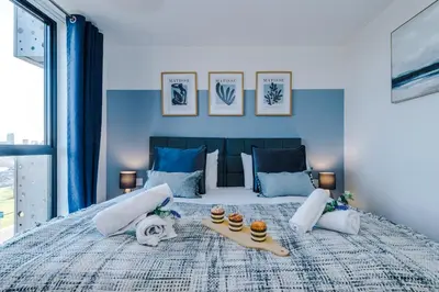 a bedroom with a large bed with blue walls at NEW! Stunning 2-bed apartment in Liverpool by 53 Degrees Property - Amazing location, Ideal for Small Groups - Sleeps 4! in Liverpool