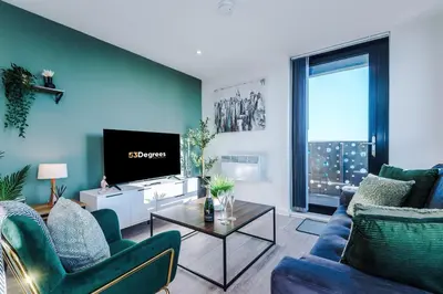a living room with a couch and a tv at NEW! Stunning 2-bed apartment in Liverpool by 53 Degrees Property - Amazing location, Ideal for Small Groups - Sleeps 4! in Liverpool