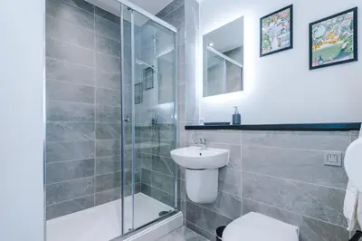 a bathroom with a shower and a toilet and a sink at NEW! Stunning 2-bed apartment in Liverpool by 53 Degrees Property - Amazing location, Ideal for Small Groups - Sleeps 4! in Liverpool