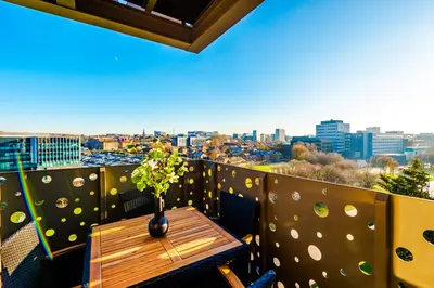 a table on a balcony with a view of the city at NEW! Stunning 2-bed apartment in Liverpool by 53 Degrees Property - Amazing location, Ideal for Small Groups - Sleeps 4! in Liverpool