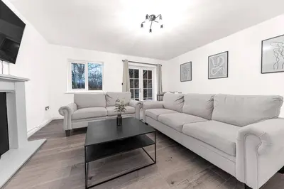 a white living room with a couch and a table at ML Short Stays - Barrow House 4 bedrooms in Roose