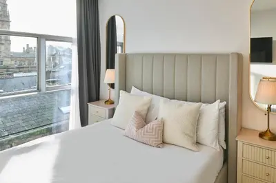 a bedroom with a large white bed with a window at Host & Stay - The Municipal View Abode in Liverpool
