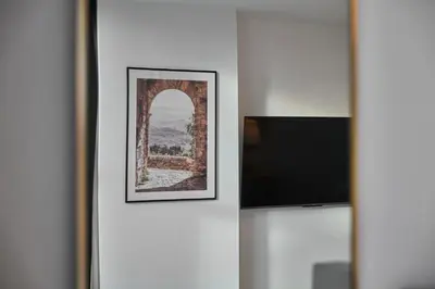a picture of an arch and a television on a wall at Host & Stay - The Municipal View Abode in Liverpool