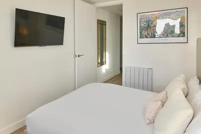 a living room with a white couch and a flat screen tv at Host & Stay - The Municipal View Abode in Liverpool