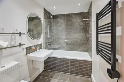 a bathroom with a tub and a sink and a shower at Host & Stay - The Municipal View Abode in Liverpool