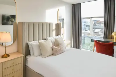 a bedroom with a large white bed with a window at Host & Stay - The Municipal View Abode in Liverpool