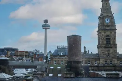 a city with a clock tower and a tall building at Host & Stay - The Municipal View Abode in Liverpool