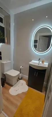 a bathroom with a sink and a toilet and a mirror at OLIVE TREE - 2 Master bedroom (sleeps 6) in Blackpool