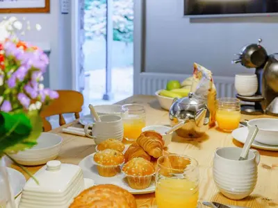 a table with pastries and glasses of orange juice at 3 Bed in Grange-over-sands oc-66725 in Holker