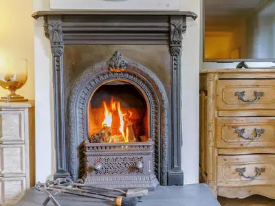 a fireplace with a fire in it in a room at 3 Bed in Grange-over-sands oc-66725 in Holker