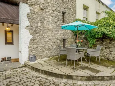 a table and chairs with an umbrella on a patio at 3 Bed in Grange-over-sands oc-66725 in Holker