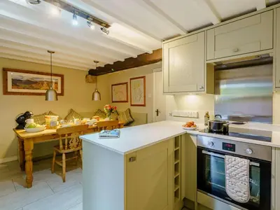 a kitchen with a stove and a table in it at 3 Bed in Grange-over-sands oc-66725 in Holker