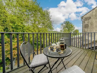 a table and chairs on a wooden deck with a table and cups at 3 Bed in Grange-over-sands oc-66725 in Holker