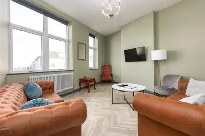 a living room with two couches and a tv at Ettie and Gigi's in Blackpool