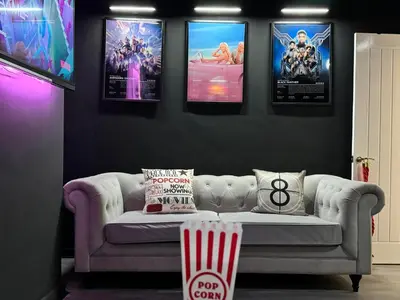 a living room with a couch and posters on the wall at Now Screening…Large Movie Place 60 Inch TV (Sleep 11) in Liverpool