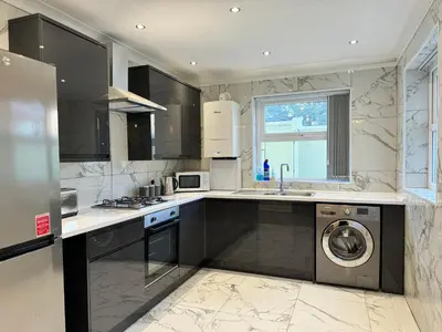a kitchen with a washer and dryer in it at Now Screening…Large Movie Place 60 Inch TV (Sleep 11) in Liverpool