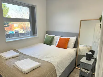 a bedroom with a large bed with a window at Now Screening…Large Movie Place 60 Inch TV (Sleep 11) in Liverpool