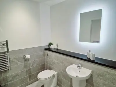 a bathroom with a white toilet and a sink at Westminster Luxury Liverpool Apartment with Free Parking in Liverpool
