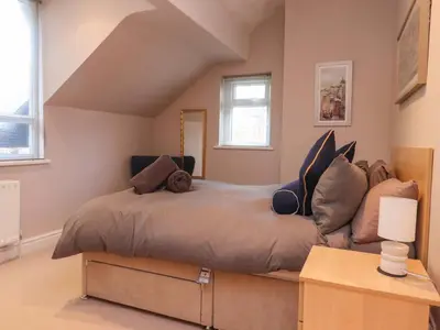 a bedroom with a large bed with pillows on it at 6D Clifton Drive in Lytham St Annes