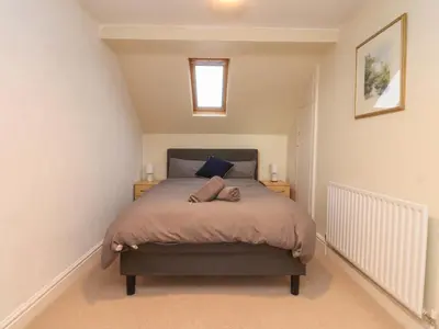 a small bedroom with a bed with a window at 6D Clifton Drive in Lytham St Annes