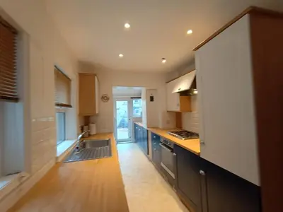 a kitchen with a sink and a stove top oven at 4 Bed house Sea Views Benji's by the beach in Morecambe