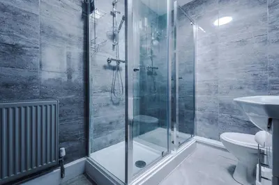 a bathroom with a shower and a toilet and a sink at LFC Themed Apartment in Liverpool