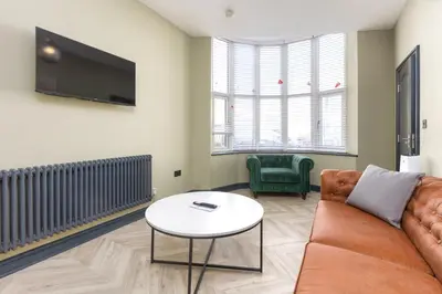 a living room with a couch and a table at Ettie's in Blackpool
