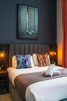 a bedroom with a large bed with pillows on it at Duke Street Townhouse by EPIC in Liverpool