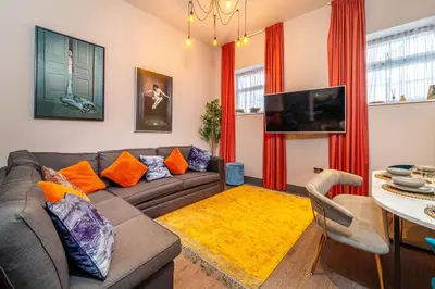a living room with a couch and a table at Duke Street Townhouse by EPIC in Liverpool