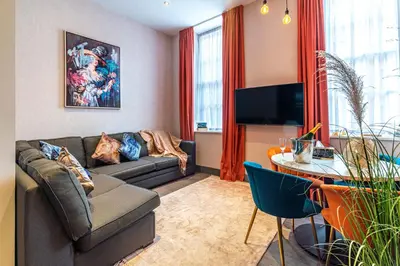 a living room with a couch and a table at Duke Street Townhouse by EPIC in Liverpool